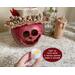 This is a fall gourd decoration is named Cora and has a lacy handmade hat. She comes with a batter-operated candle to light up her smile.